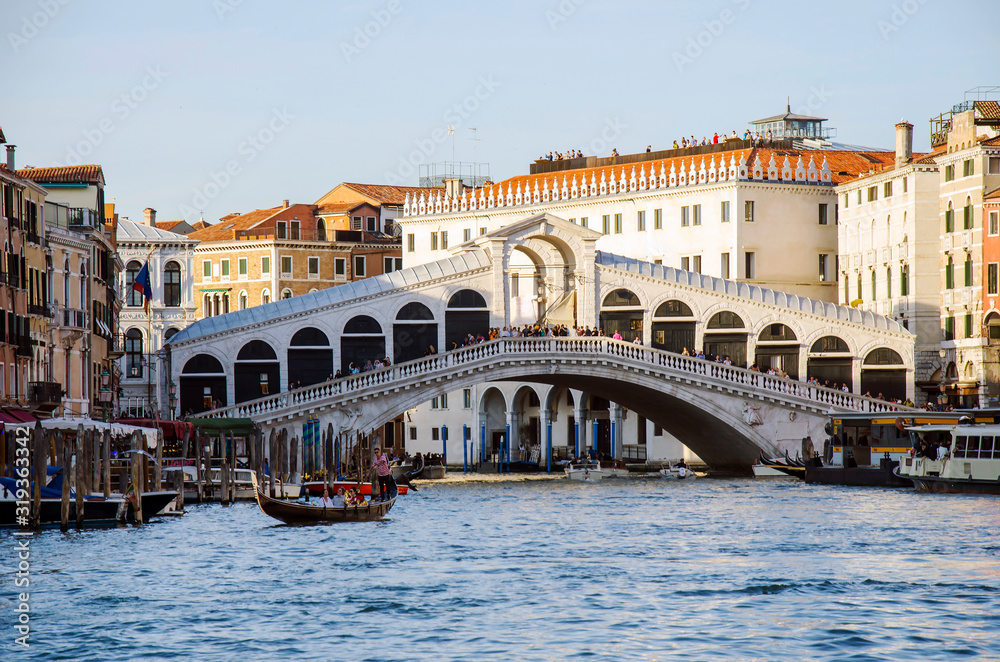 View of Bridge Rialto on Grand canal abd gondola boat, Venice, Italy