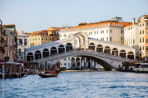 View of Bridge Rialto on Grand canal abd gondola boat, Venice, Italy © Maria Vonotna