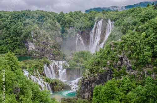 View of big waterfalls in Plitvice national park (Nacionalni park Plitvička jezera), Croatia. Cascade of two big waterfalls in summer. Mountain forest waterfall landscape.