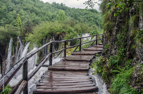 Fototapeta Naklejka Na Ścianę i Meble -  Wooden pathway near big waterfall, Plitvice Lakes National Park, Croatia