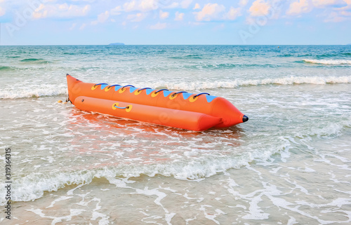 Colorful banana boat floating near the shore
