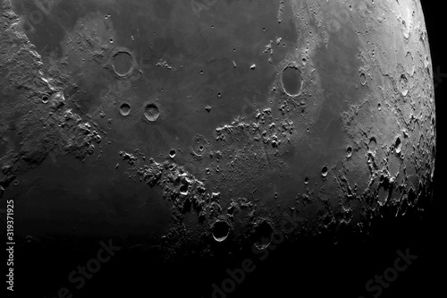 Astronomical photograph of the moon. Lunar surface through a telescope. The moon with a large increase. Craters after hitting meteorites. The Moon is the Earth's satellite. Photos from the lunar orbit