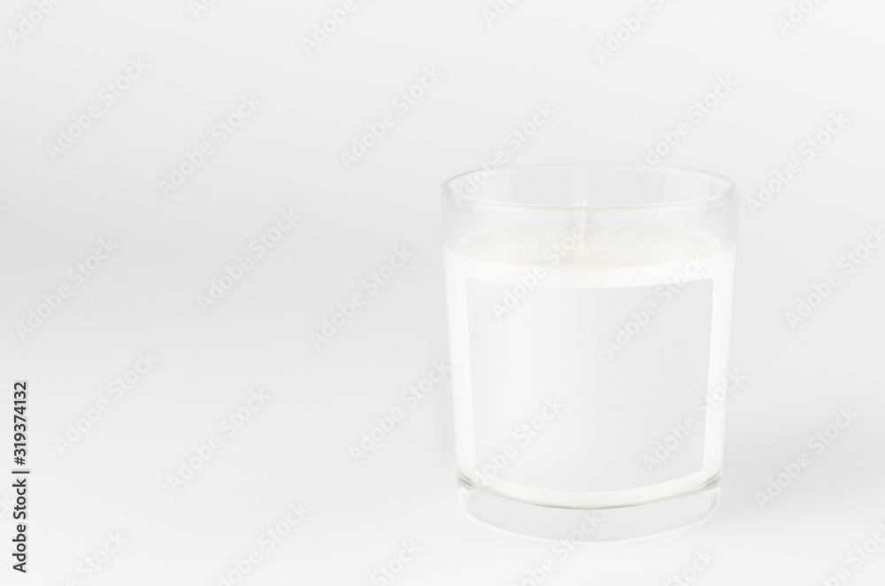 Candle in transparent glass with white blank label on white background, mock up for branding identity product, advertising, presentation, design packing. Candle in transparent glass with white blank label on white background, mock up for branding identity product, advertising, presentation, design packing.
