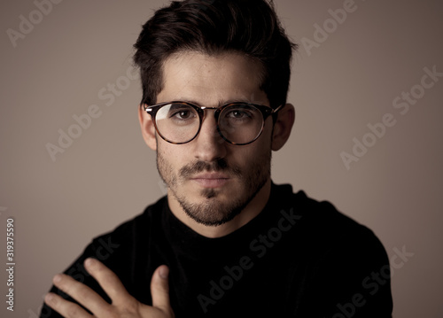 Young attractive latin man with glasses posing looking sensual and handsome. Beauty concept and lifestyle © SB Arts Media