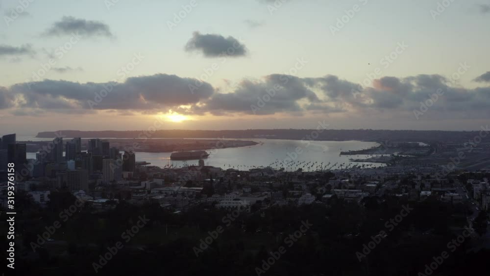 Helicopter footage from Balboa Park during a beautiful Sunset with the San Diego, California skyline is the background. 