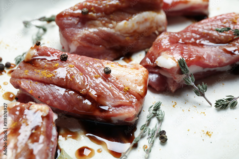 Raw marinated ribs with thyme and peppercorn, closeup