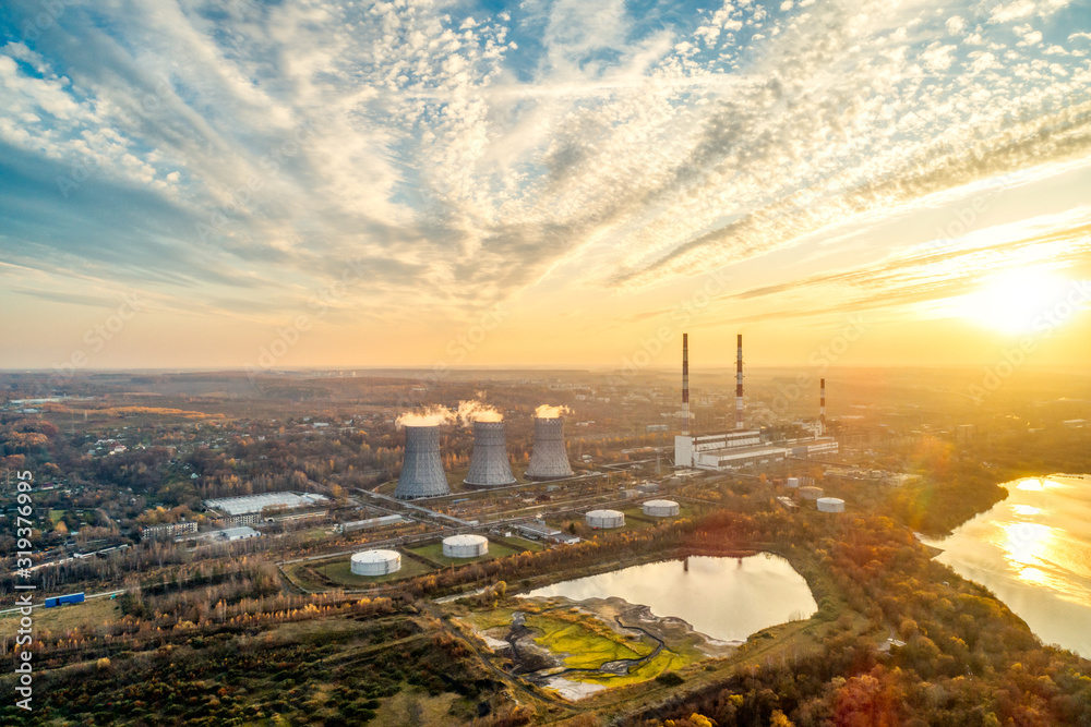 Obraz premium State District Power Station generating heat and electricity. High pipes and cooling towers are visible. Aerial view.