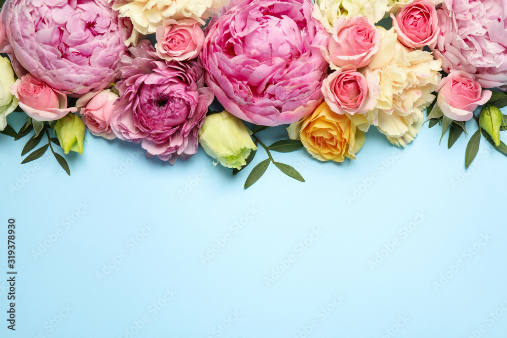 Flat lay composition with beautiful flowers and space for text on light blue background. Floral card design - obrazy, fototapety, plakaty 