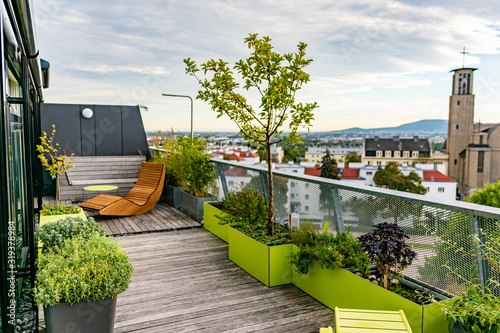 Schilderij op canvas Rocking lounger on a roof terrace with bamboo and grasses and outdoor furniture