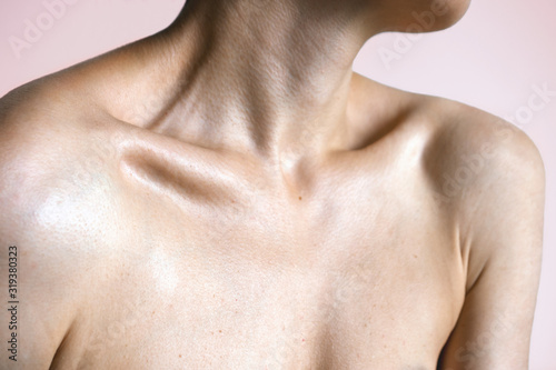 Neck shoulders and collarbones of a beautiful woman photo