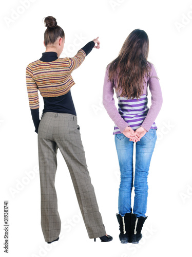 Back view of two pointing young girl in sweater.