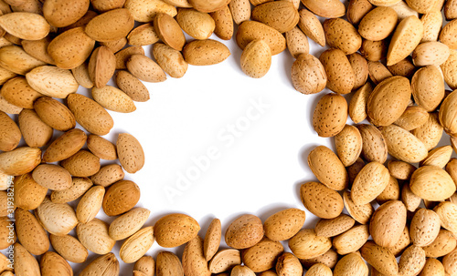 walnut background with place for an inscription. unpeeled almonds and light round copy space