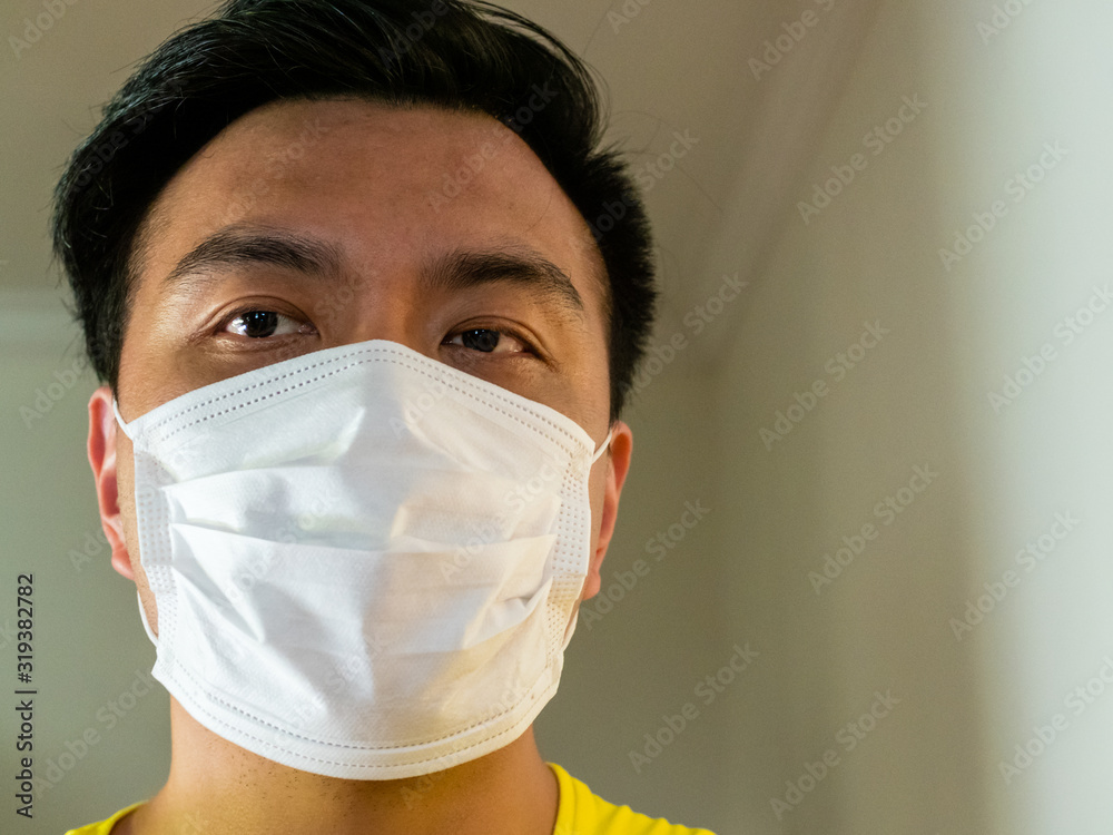inflation stramt redde Headshot of Asian Chinese man / person wearing a surgical face mask as  protection against transmission / infection of contagious viruses with copy  space Stock Photo | Adobe Stock