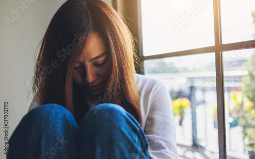 A sad young woman sitting alone in the room Free Download A sad young woman sitting alone in the room - GFXLoad