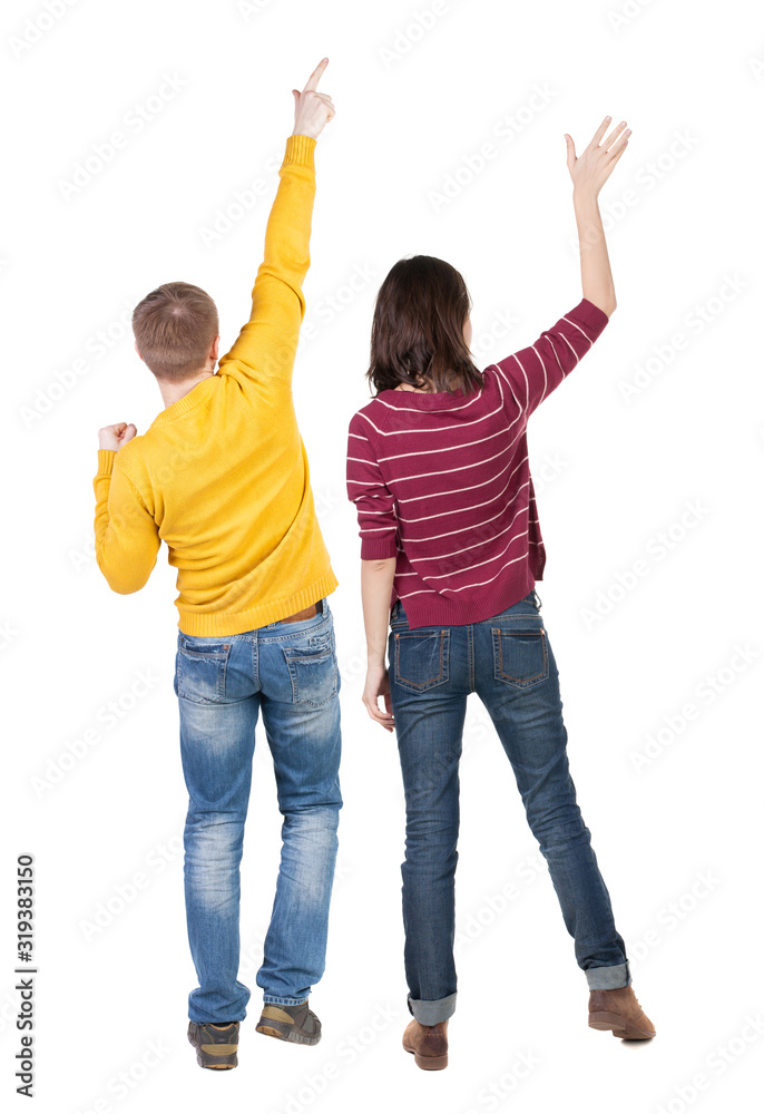 Back view of couple couple in sweater pointing. Back view of couple couple in sweater pointing.