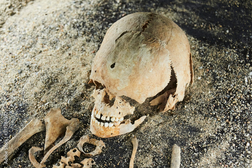 Excavation of graves. Ancient remains of body. Exhumation. Selective focus. Abandoned archeological site. Studio lighting