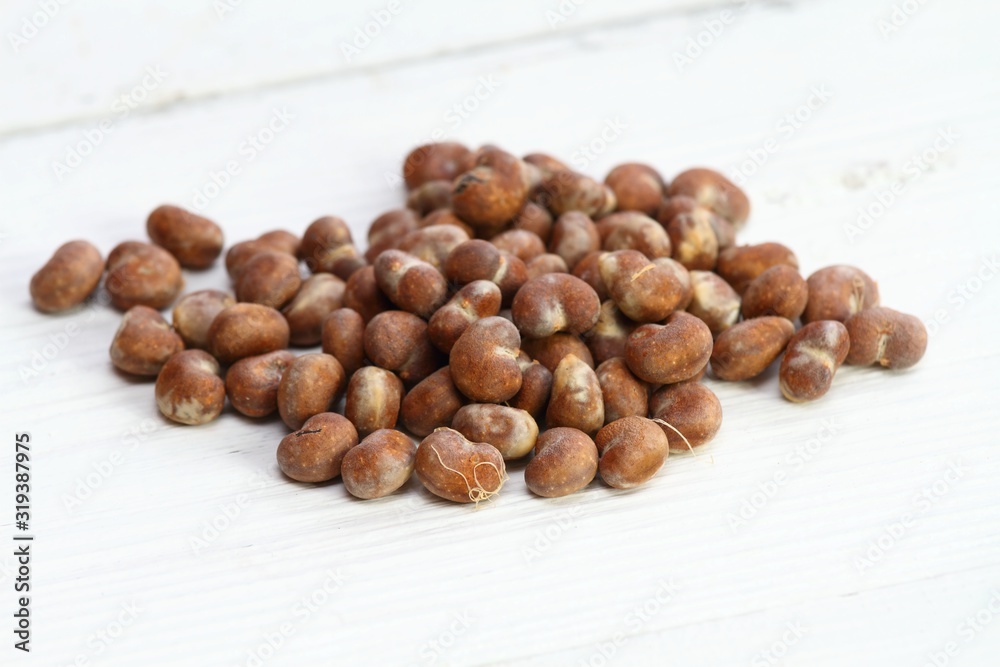 Baobab seeds on the wooden table. Heap of baobab, Adamsonia digitata, seeds on the white table Baobab seeds on the wooden table. Heap of baobab, Adamsonia digitata, seeds on the white table