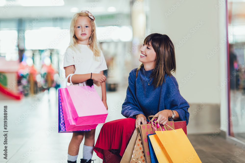 Mother and daughter having fun in shopping mall toghether. Mother and daughter having fun in shopping mall toghether.