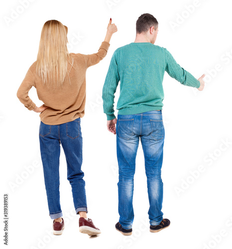 Back view of couple couple in sweater showing thumbs up.