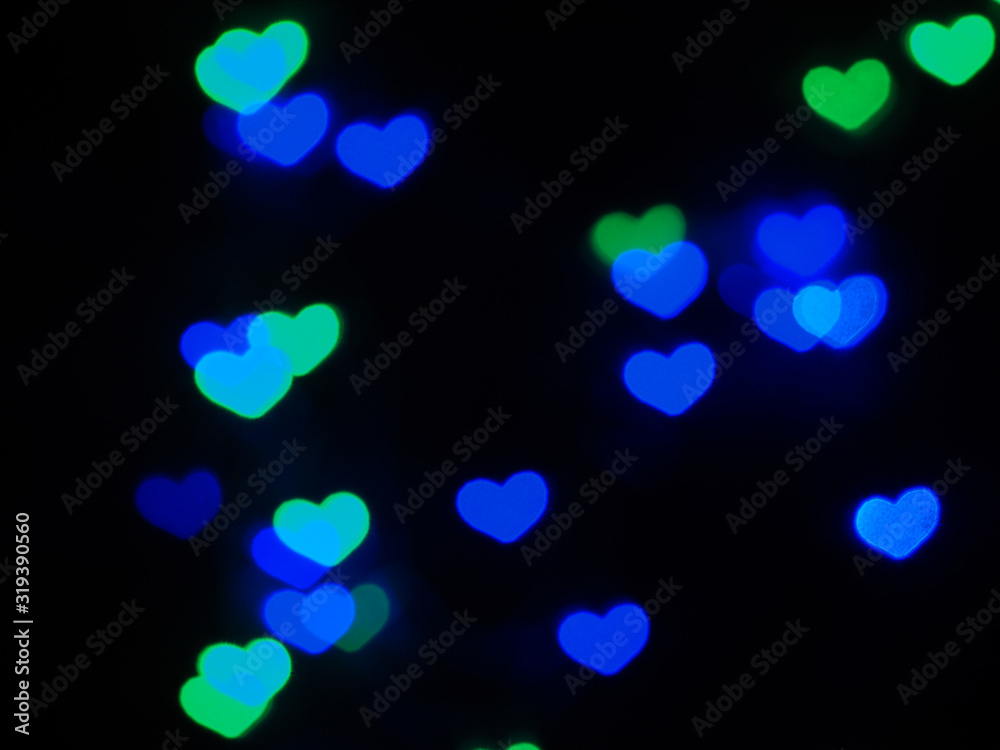 Blue and green heart shaped bokeh on black background. Valentine's day,love,anniversary concept..