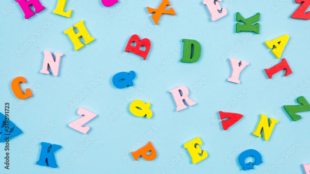 Multicolored letters on a blue background. Multicolored letters on a blue background.