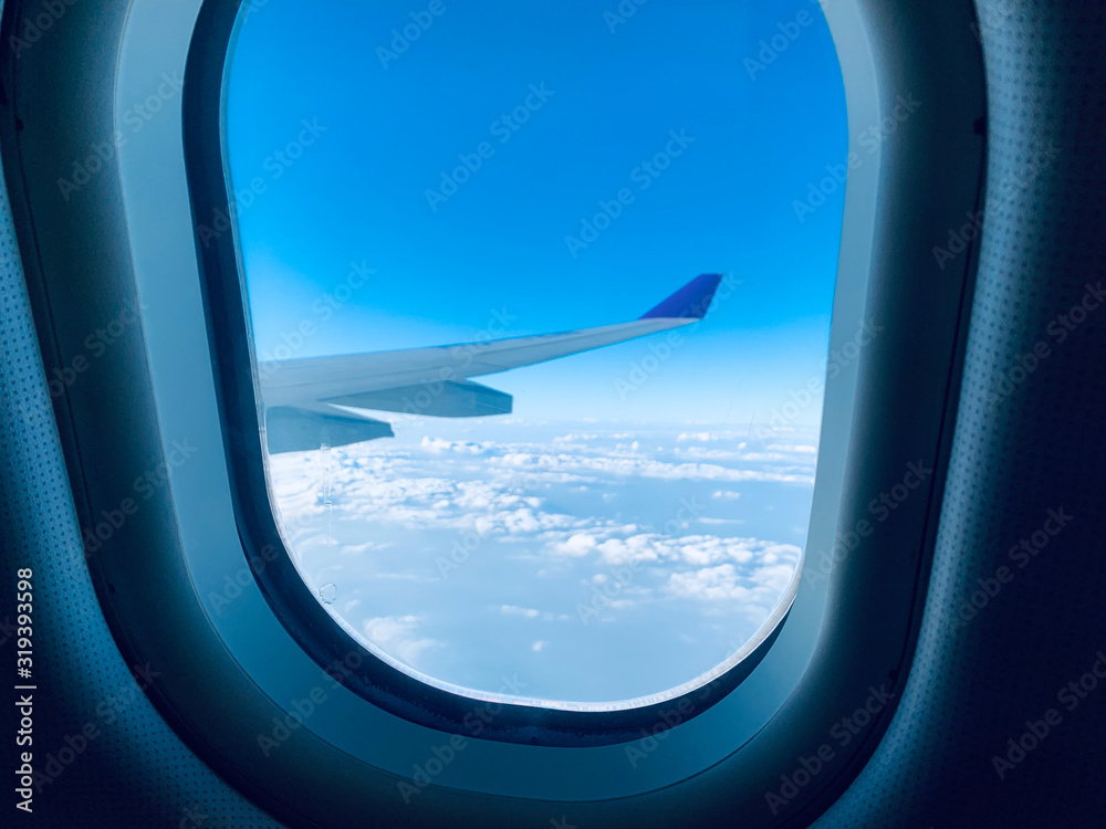 The windows and wings of the plane saw the clouds. The windows and wings of the plane saw the clouds.