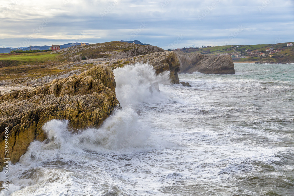 Waves breaking against the cliffs