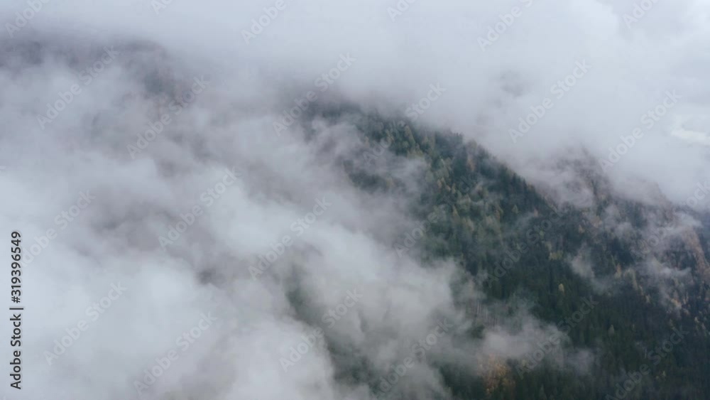 Aerial view. Flying over high mountain in beautiful clouds. Aerial view. Flying over high mountain in beautiful clouds.