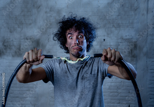 Photos Funny image of man getting electric shock with funny face and smoke all around