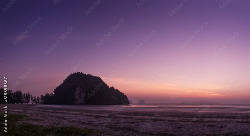 view seaside evening of mountain on sand beach with purple sky background, twilight at Chao Mai beach, Had Chao Mai National Park, Trang Province, southern of Thailand.
