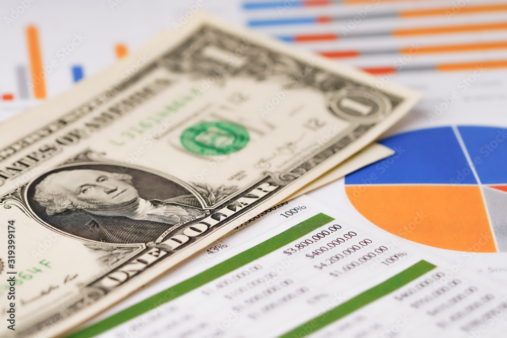 US dollar banknotes on graph spreadsheet paper. US dollar banknotes on graph spreadsheet paper.