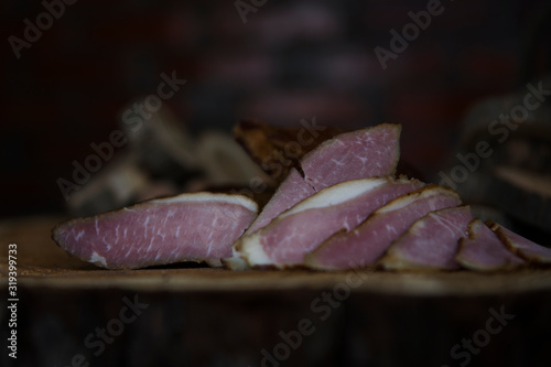 Prosciutto Served on a Rustic Wooden Surface. Smoked Cured Ham, Delicious, Domestic, Traditional Food photo