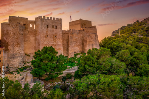 Aerial sunset view of Cullera church and castle with rectangular keep towering over the popular Spanish vacation resort town photo