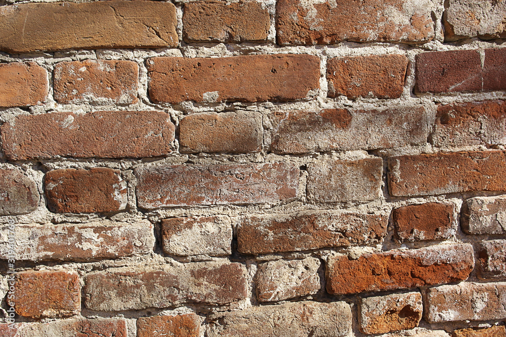 Obraz premium Old brick wall. The structure of the old red brick is clearly visible. Old masonry.