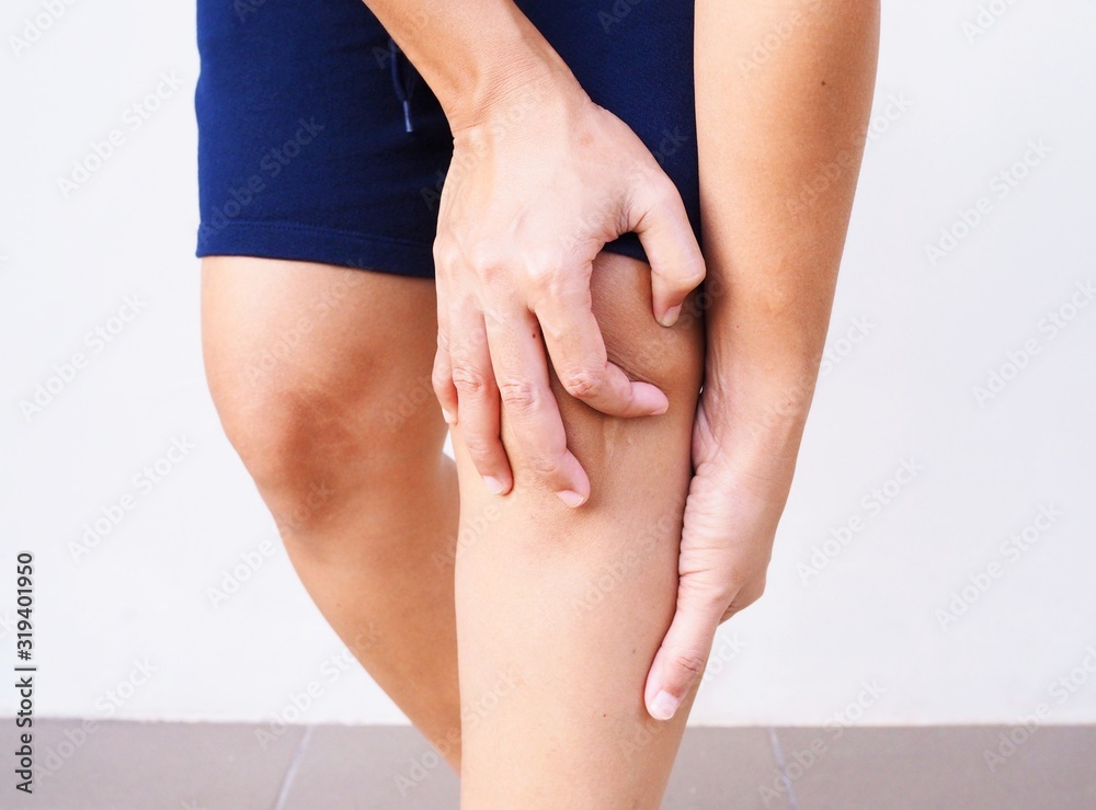 Φωτογραφία Asian people have knee pain, leg pain use hands touching on leg massage to relax muscle and relieve ache