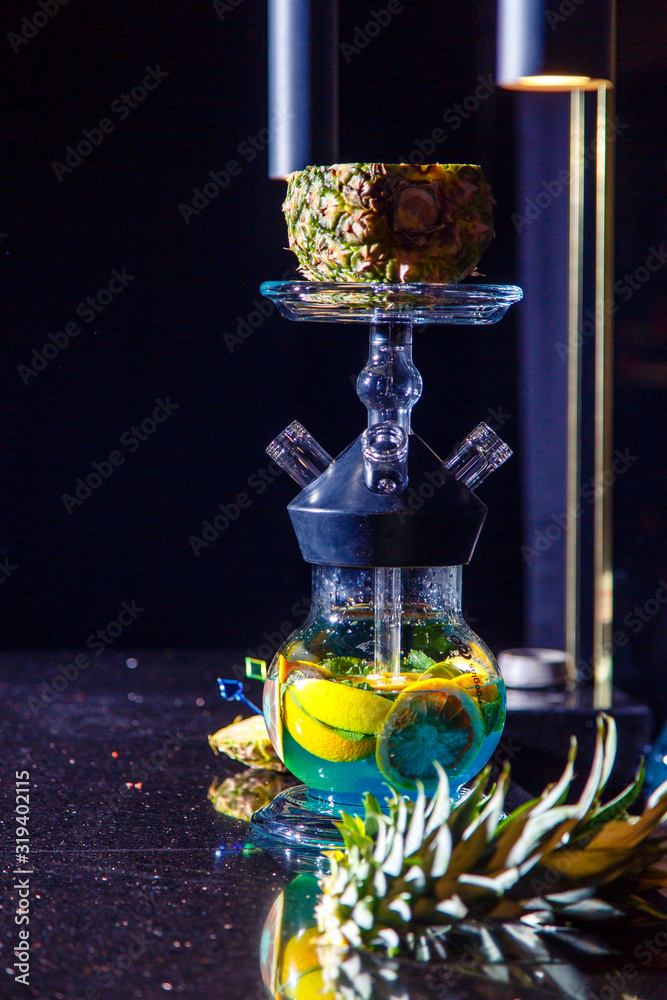 Manufacturing of hookah in the pineapple. The cut pineapple lies in the