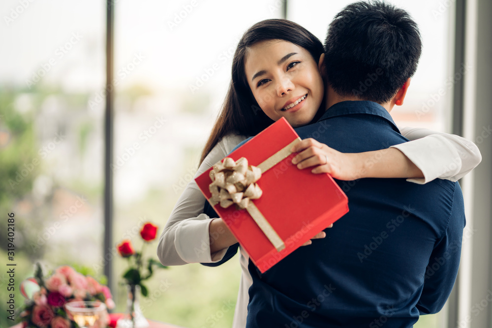 Young handsome man giving gift box surprise to girlfriend Young handsome man giving gift box surprise to girlfriend