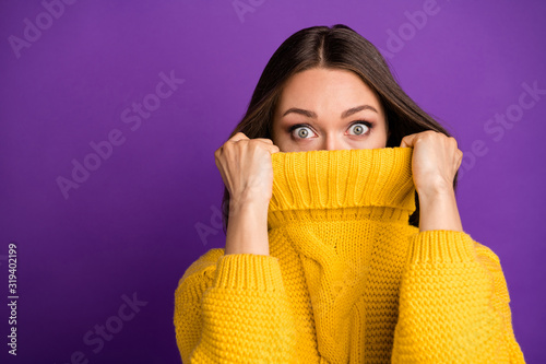 Close-up portrait of her she nice attractive lovely funny scared straight-haired girl hiding face in warm sweater isolated over bright vivid shine vibrant lilac violet purple color background