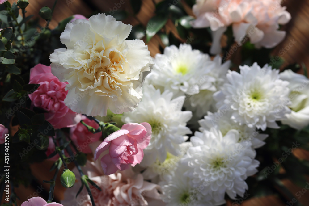 Super cute, light color flower bouquets including baby pink and white dianthus flowers with white chrysanthemum flowers, and some other white flowers. Photographed with a white wall on the background. Super cute, light color flower bouquets including baby pink and white dianthus flowers with white chrysanthemum flowers, and some other white flowers. Photographed with a white wall on the background.