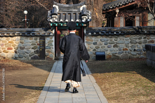 Fotografie A confucian scholar is walking in korean traditional clothing at Jeonju Hyanggyo in Jeonju, South Korea