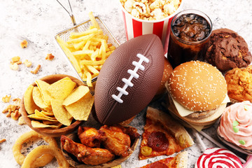 chicken wings, fries and onion rings for football on a table. Great for Bowl Game party