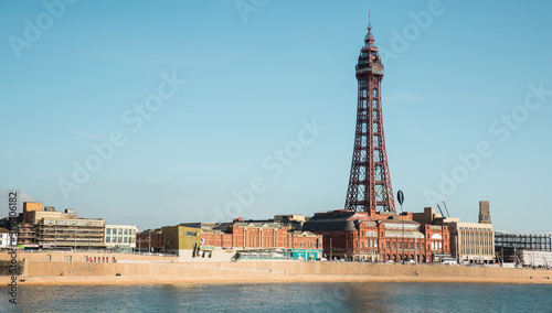 Blackpool, England, 19/09/2019 Beautiful landscape image of the the famous Blackpool Tower on the seaside promenade of the north west, a hotspot for holidays and British tourism. Blue sky and water photo