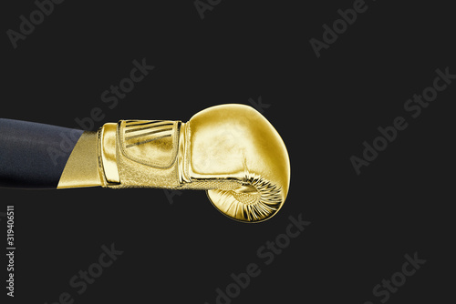 Gold boxing glove. Sport and fight concept. The man deals a blow with a gold glove, a strong, strong blow. Fight and victory.