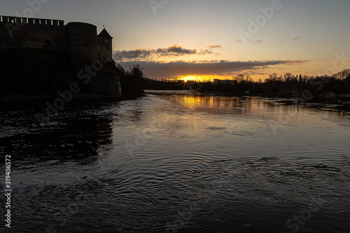 Beautiful winter dawn over the river and the fortress. Noise effect applied