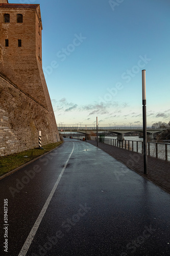 Beautiful river embankment overlooking the medieval castle and the fortress wall. Walk in the early morning in winter © M.V.schiuma