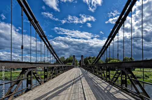 Unique chain cable-stayed bridge against a beautiful blue sky with clouds (Ostrov, Pskov oblast, Russia)