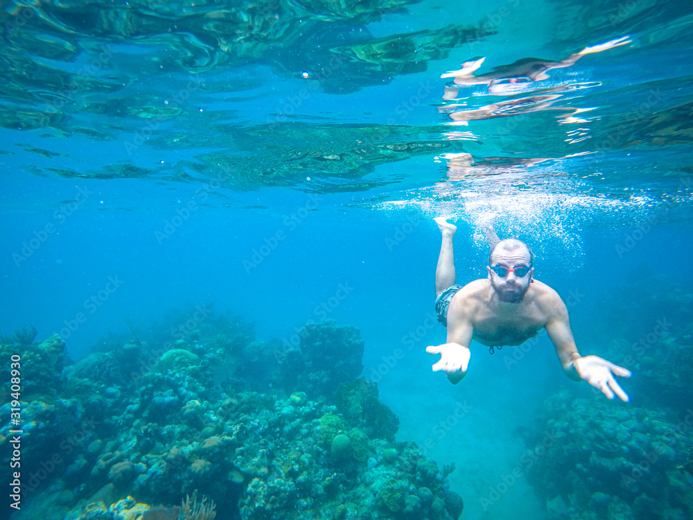 Roatan, Honduras »; December 30, 2019: A tourist snorkeling at West Bay beach on the Caribbean island Roatan Roatan, Honduras »; December 30, 2019: A tourist snorkeling at West Bay beach on the Caribbean island Roatan