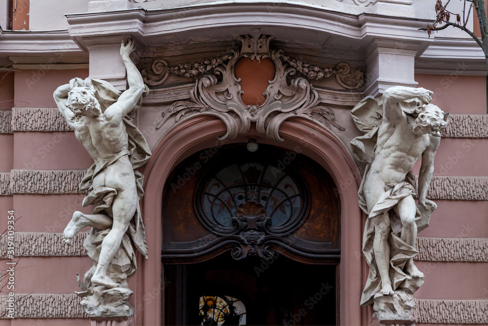 Stone sculptures in front of an entrance to House of Scientists
