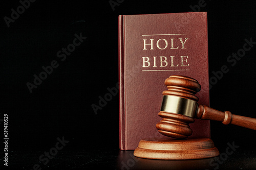 judge gavel with holy bible on black background