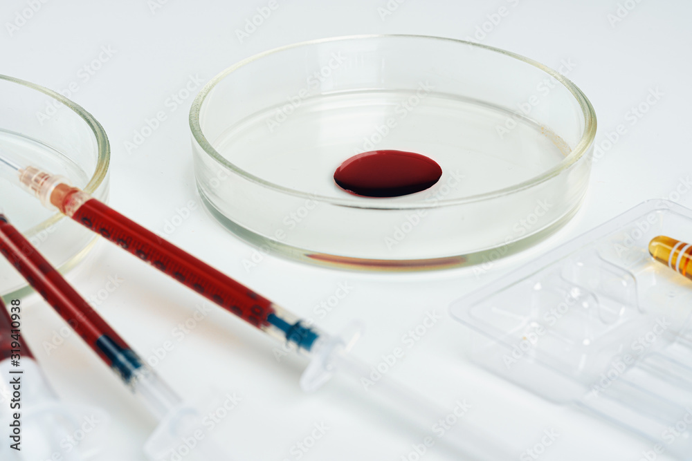 Glass dropper and Petri dish on laboratory table Glass dropper and Petri dish on laboratory table